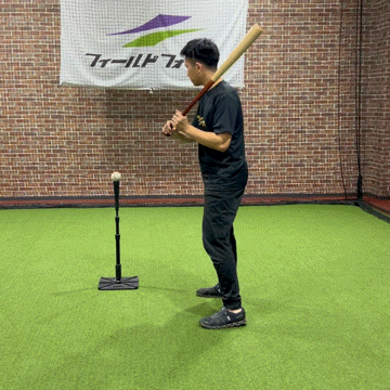 A baseball player practices adjusting the point of contact