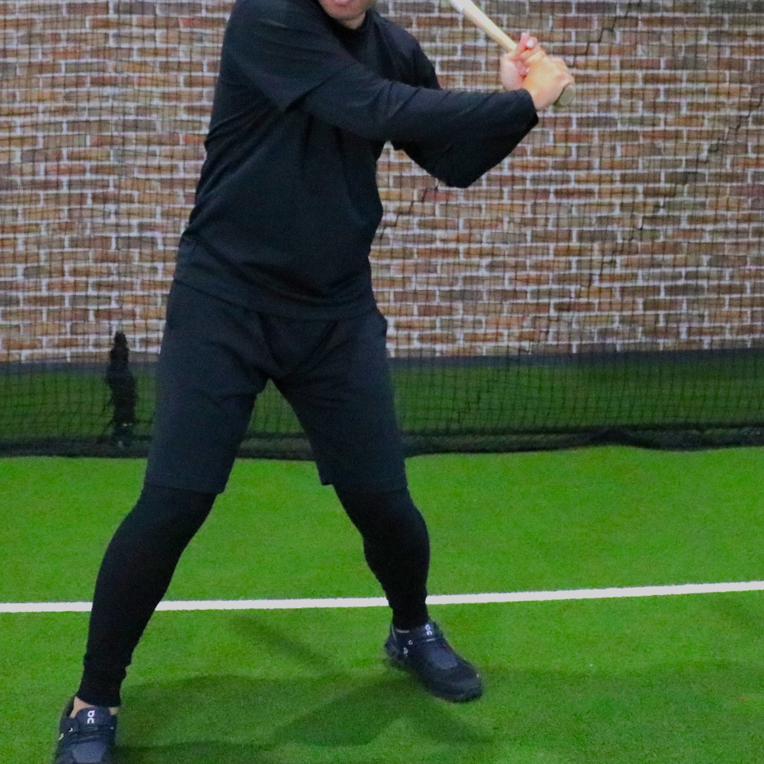 Player starting a swing with a bat