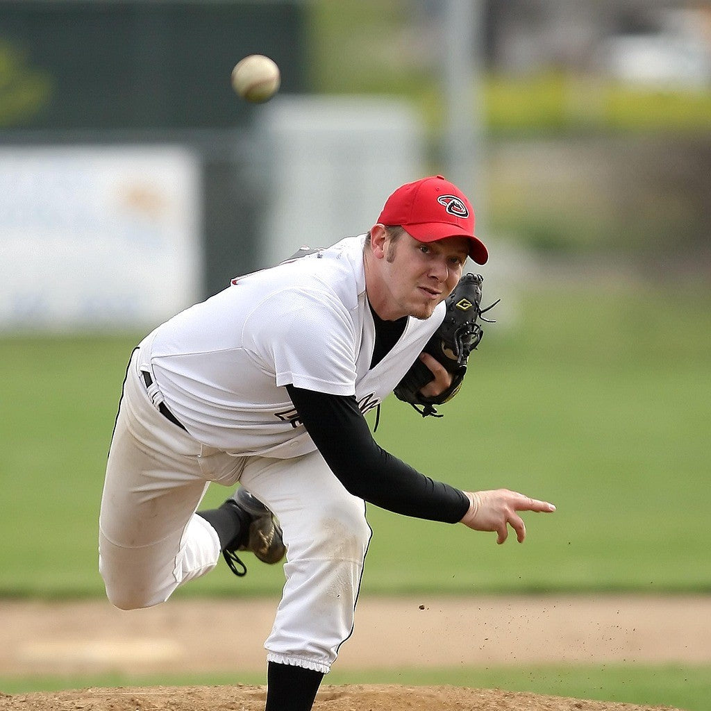 The pitcher following through after releasing the ball.