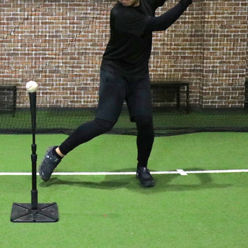 Batter’s stance in front of a tee stand