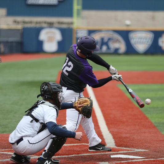 Alt Text: A batter hitting the ball at the moment of impact