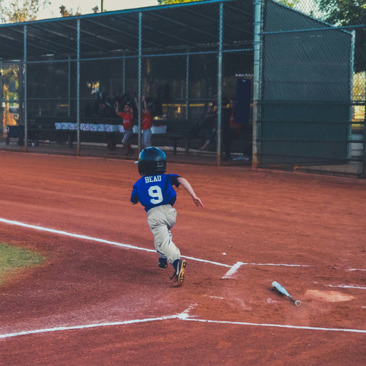 Boy running toward first base