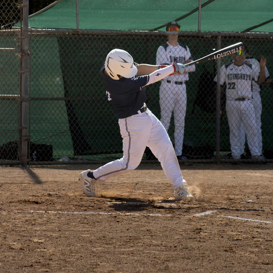 A baseball player swinging at the ball