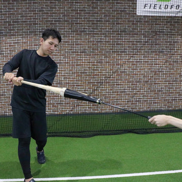dad uses fishing pole for batting practice Tee Rod